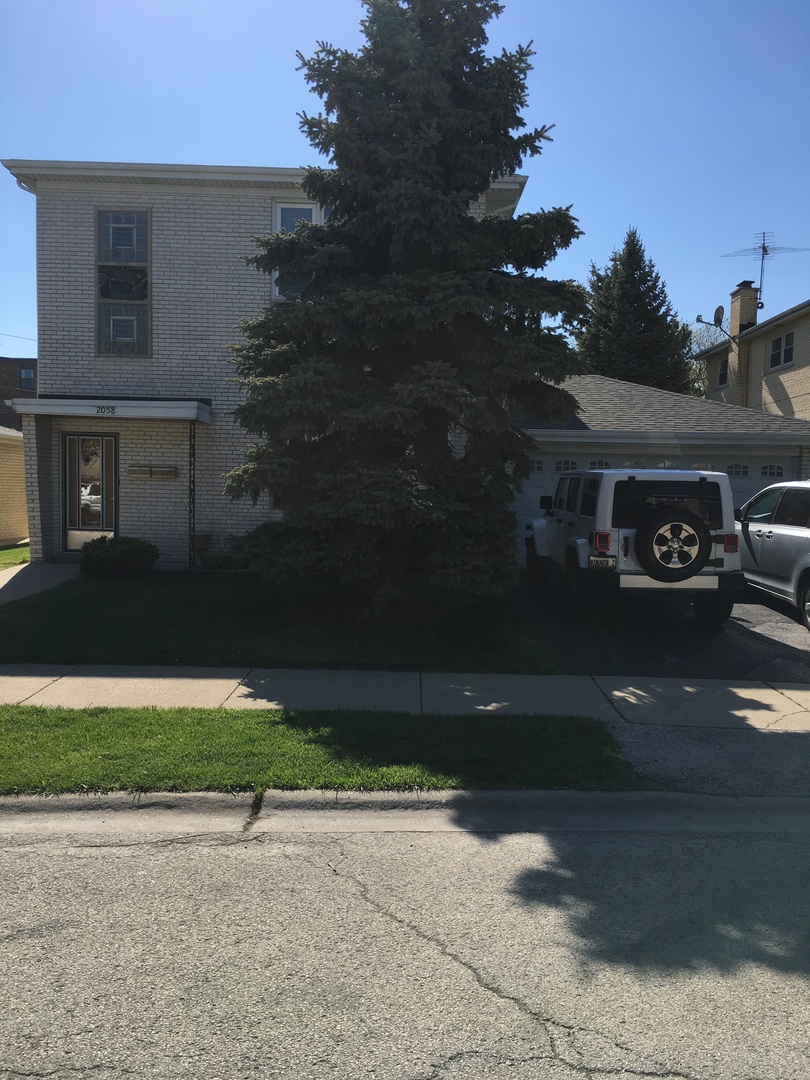 a view of a car park in front of a house