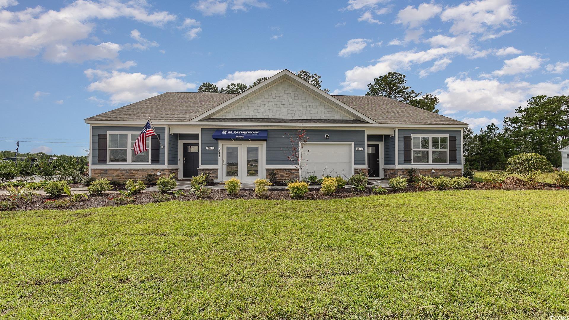 Craftsman inspired home featuring a garage and a f