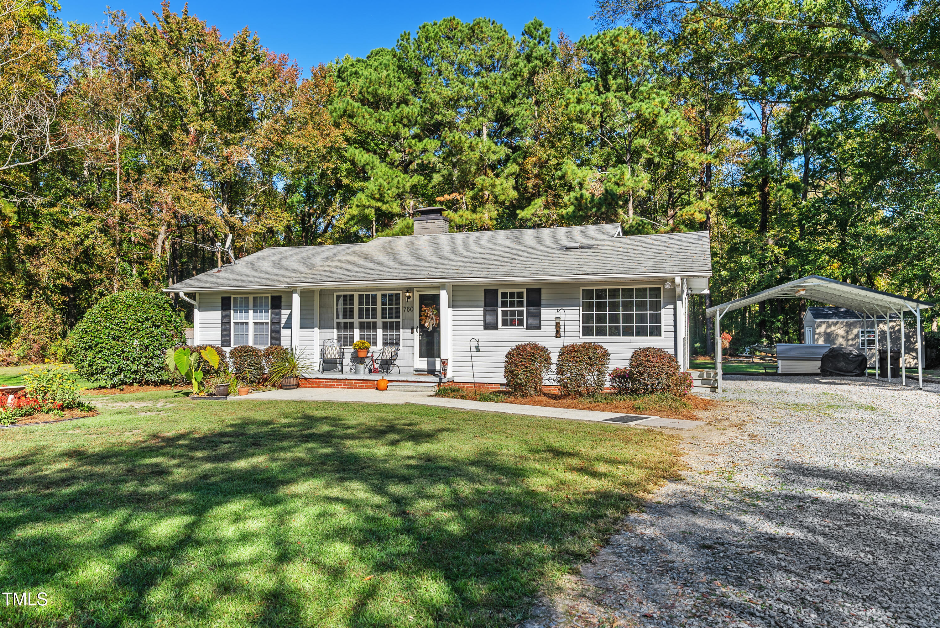 a front view of a house with yard porch and furniture