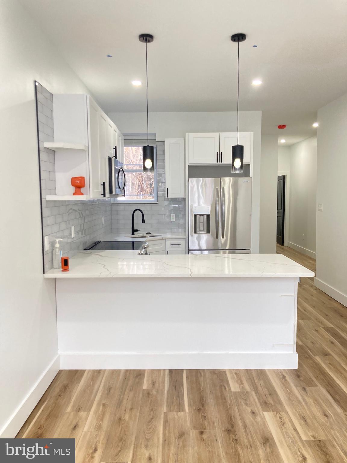 a bathroom with a sink a mirror and a shower