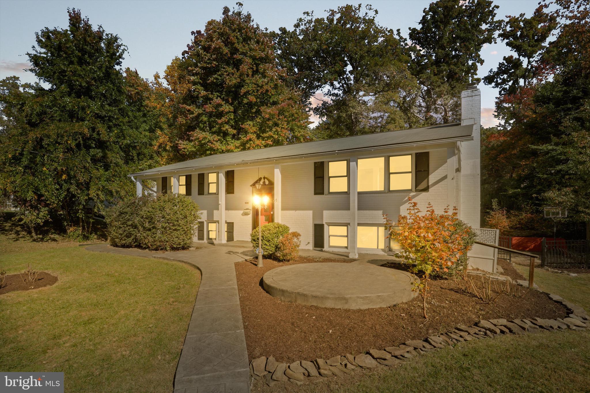 a view of a house with backyard and sitting area