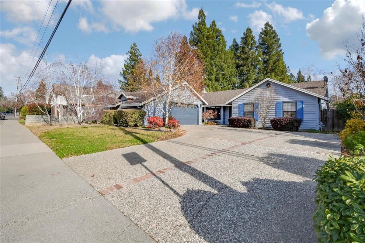 a front view of a house with a yard and trees