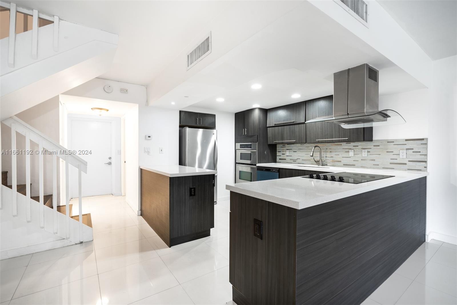 a kitchen with stainless steel appliances kitchen island a sink stove and cabinets