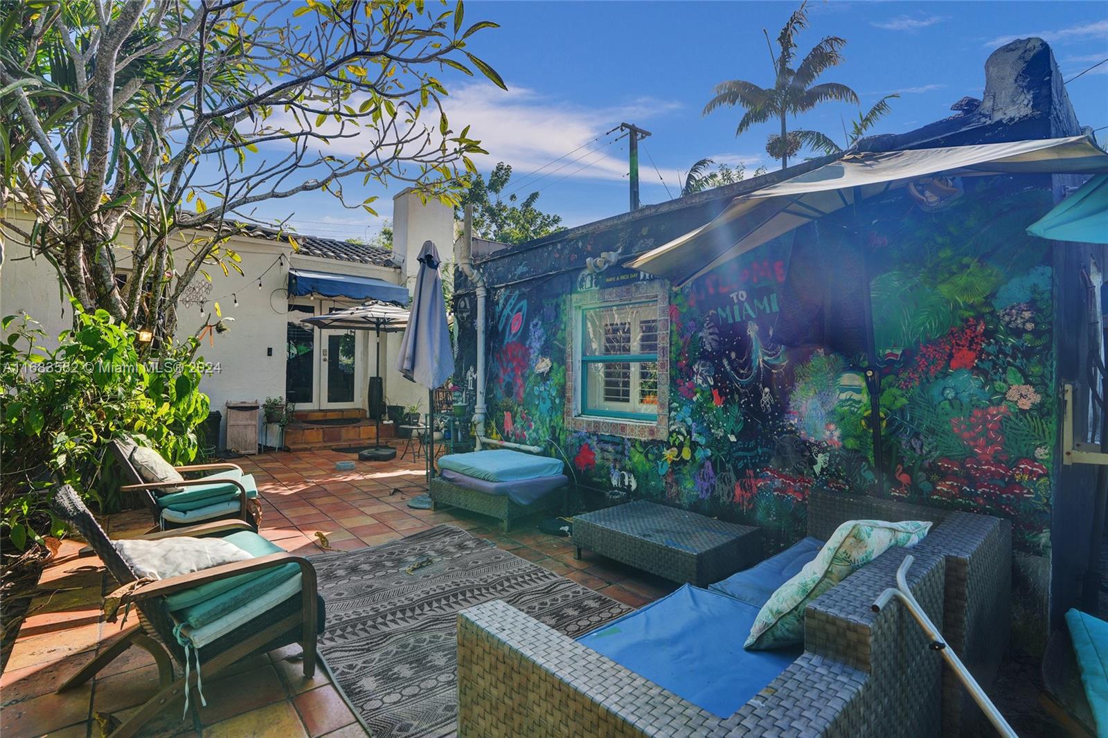 a view of a house with backyard and sitting area