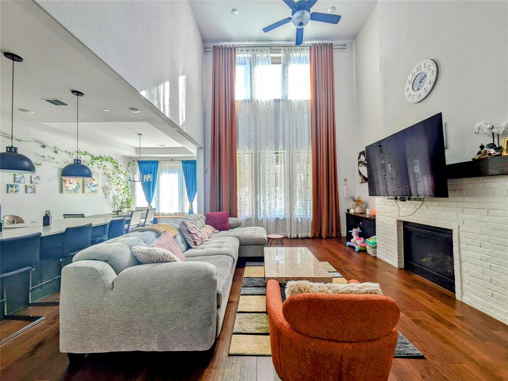 a living room with furniture a fireplace and a flat screen tv