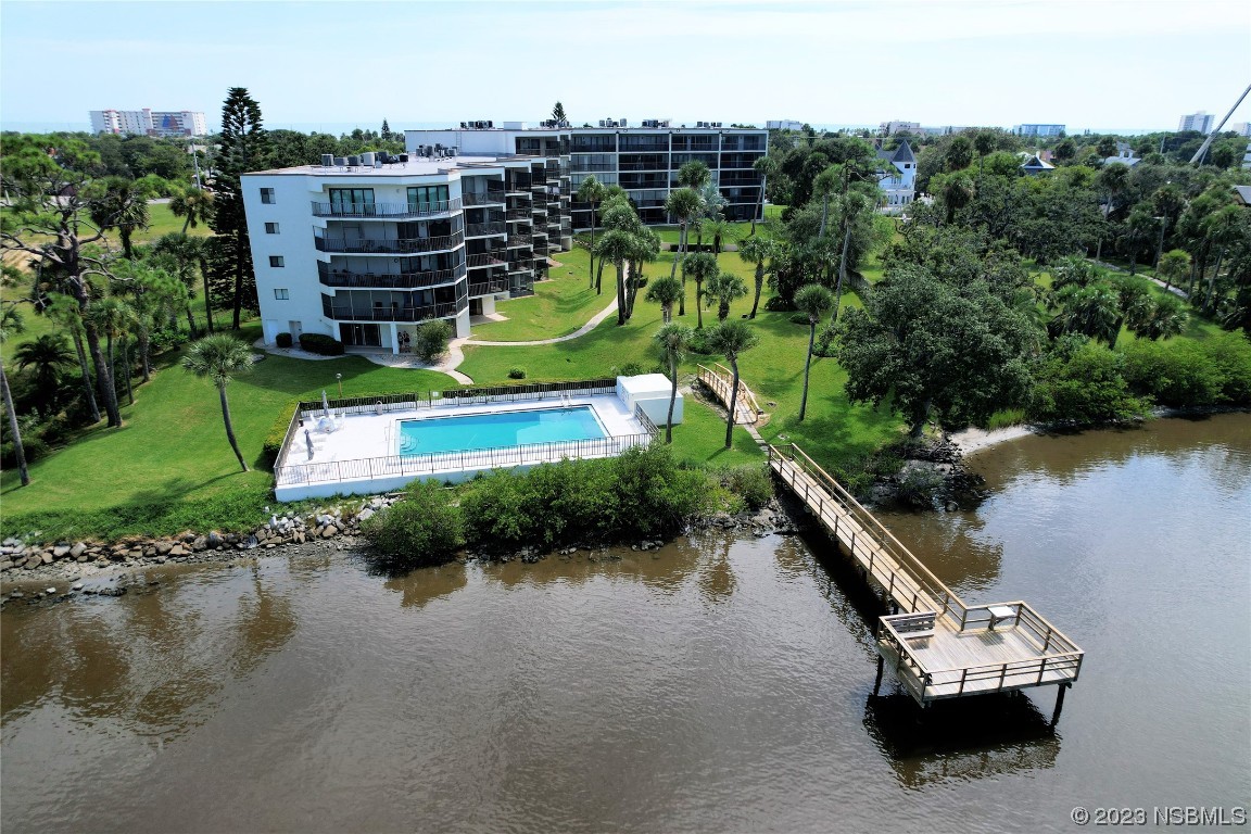 an aerial view of a house with a garden and lake view