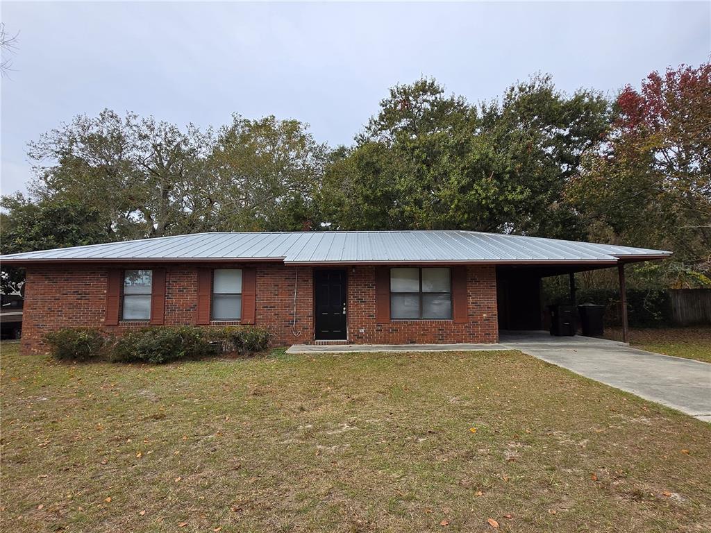 a front view of house with yard and trees