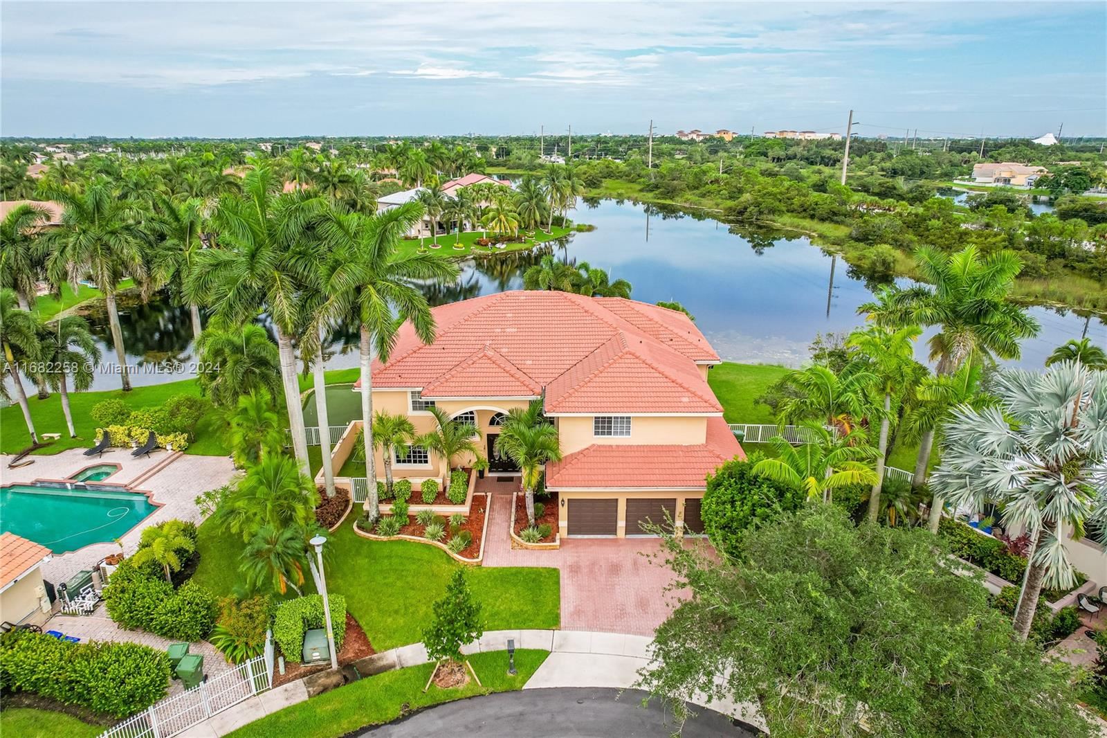 an aerial view of house with yard and lake view