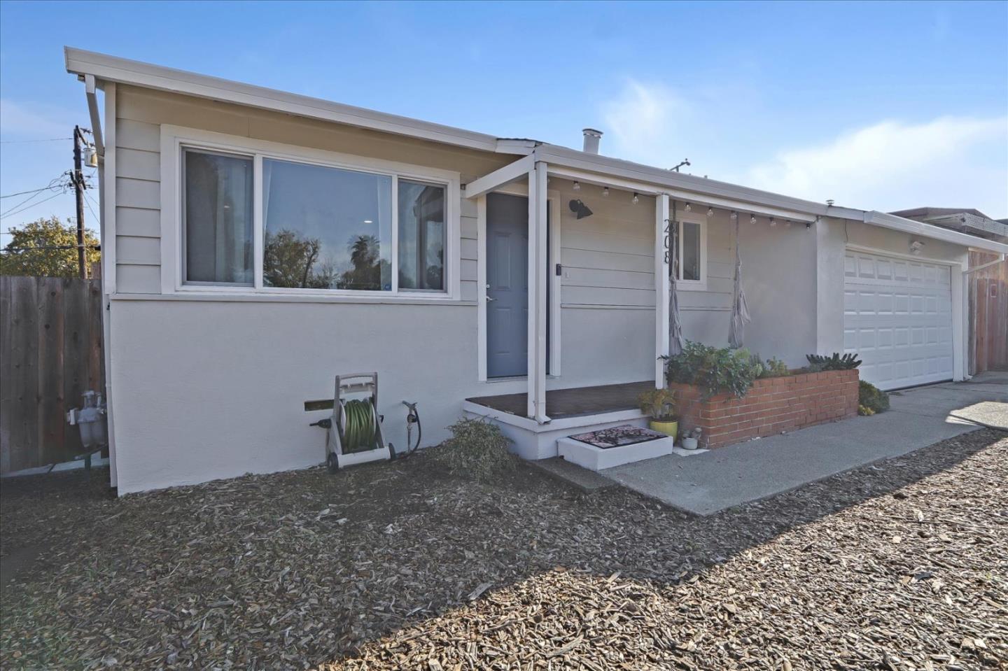 a view of an house with backyard space and garden