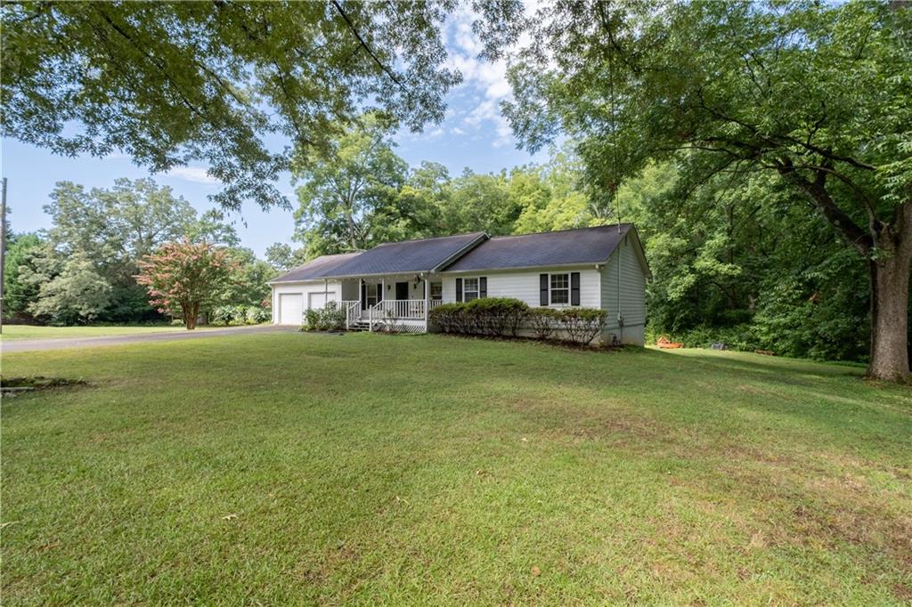 a front view of house with yard and green space