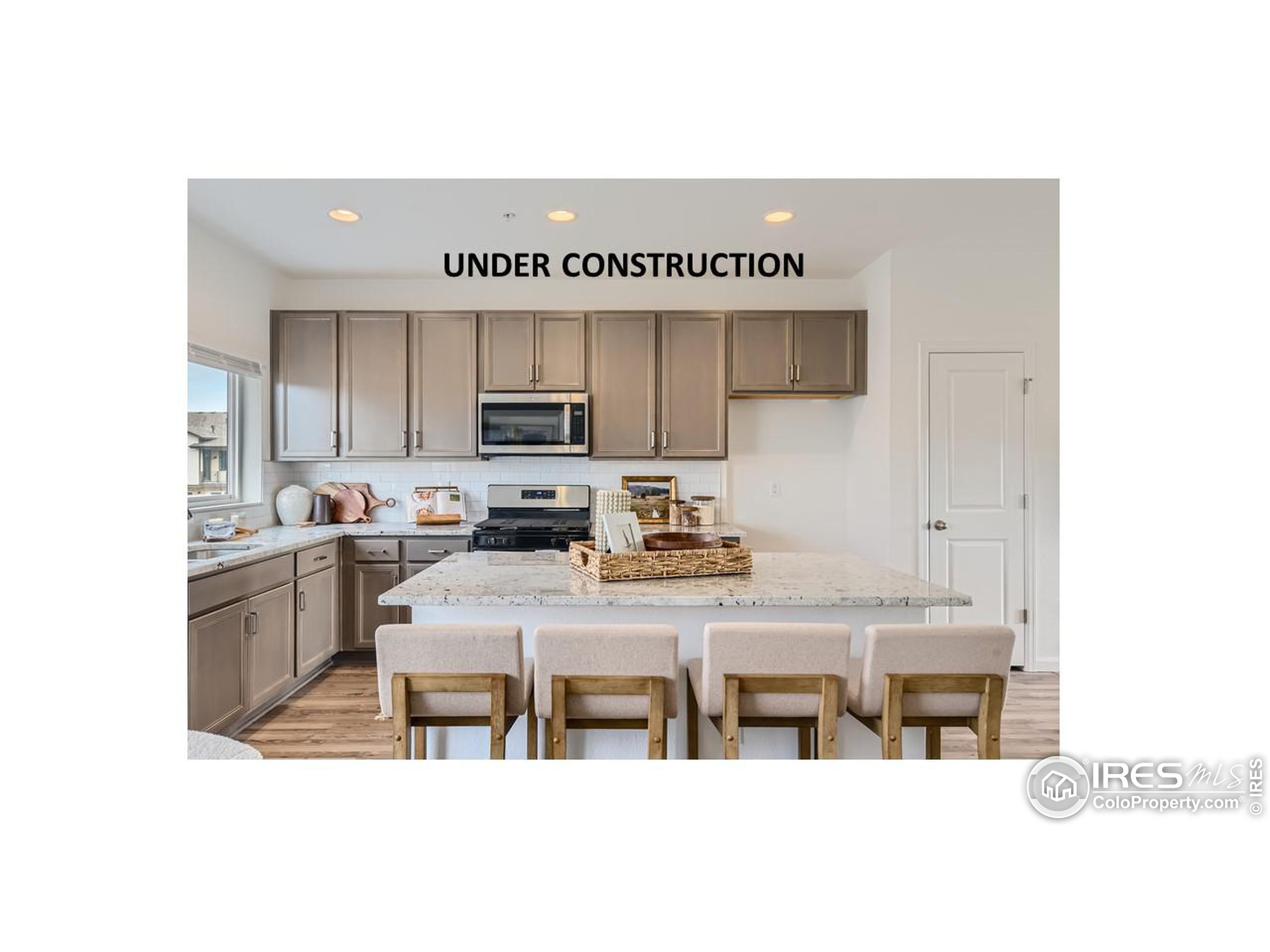 a kitchen with cabinets and chairs