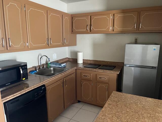 a kitchen with stainless steel appliances granite countertop a refrigerator sink and cabinets