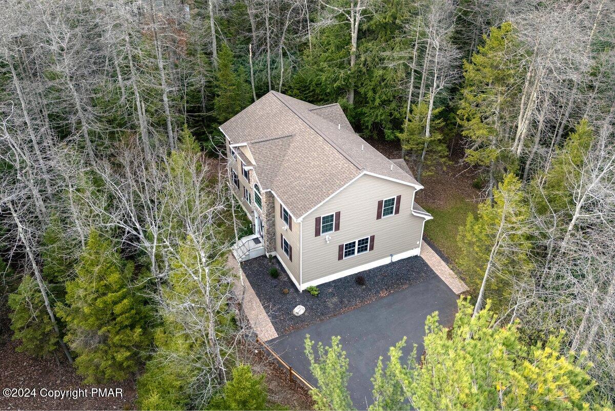 an aerial view of a house with a yard