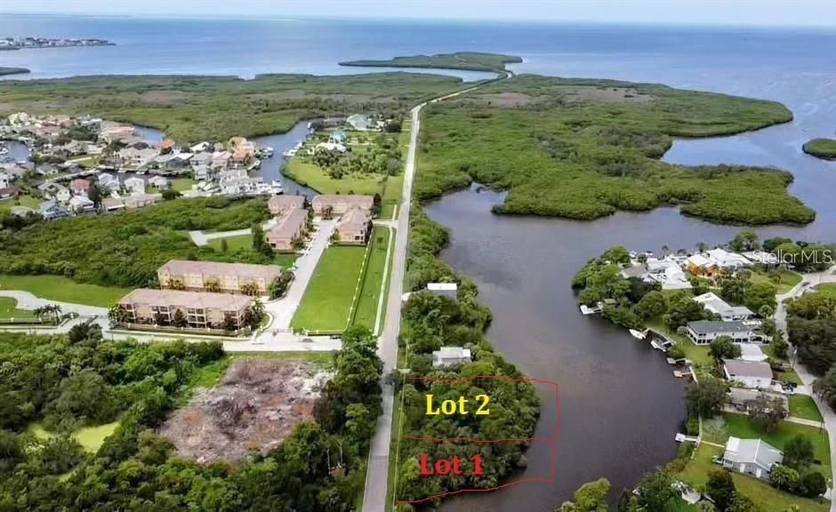 an aerial view of a house with a garden and lake view