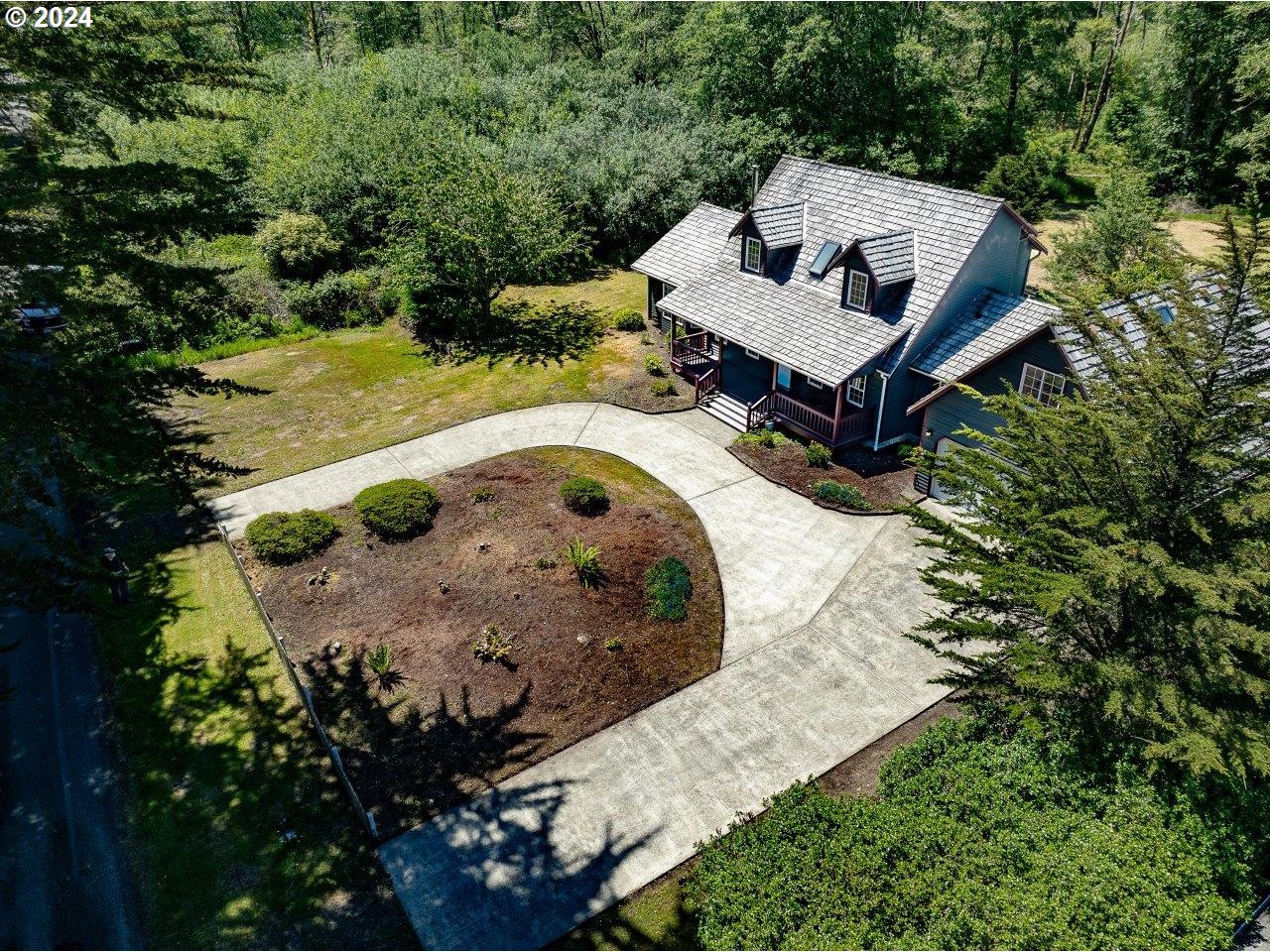 an aerial view of a house with a yard