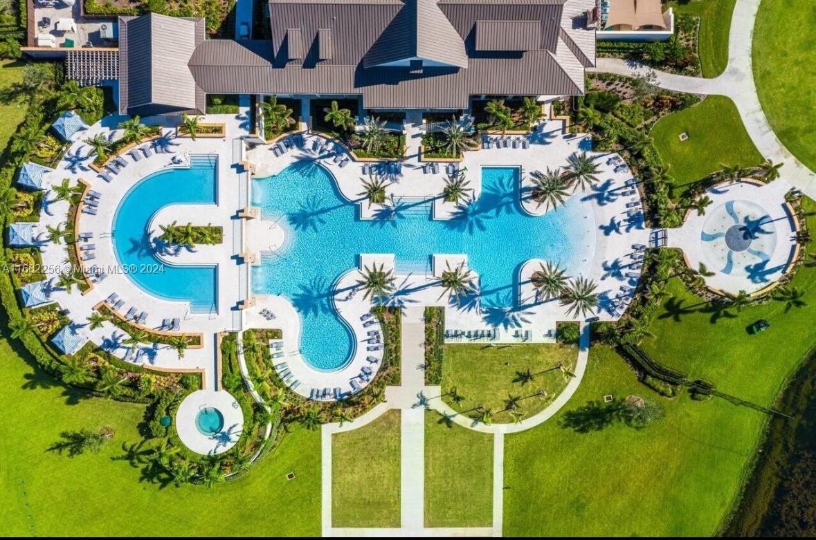 an aerial view of a swimming pool with outdoor seating