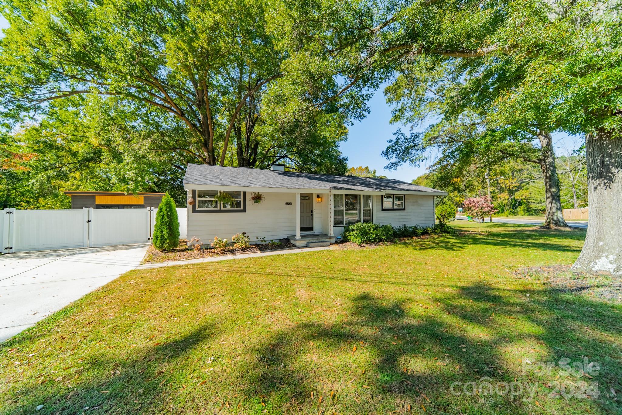 a front view of a house with a yard and trees