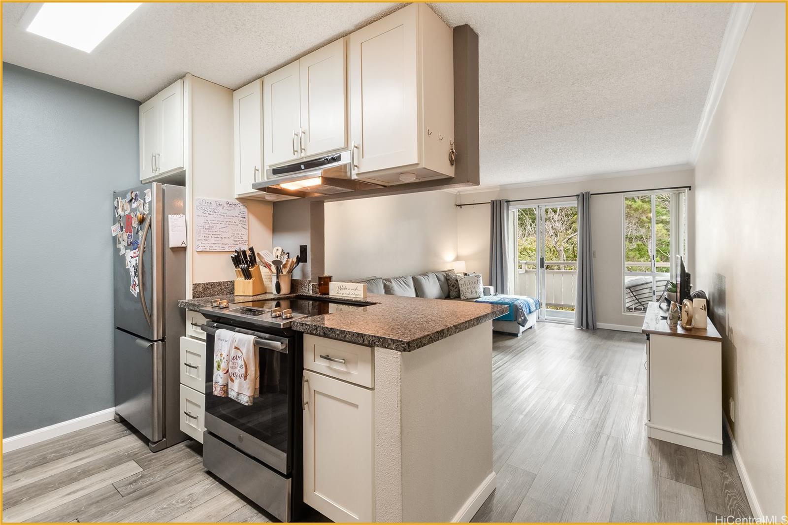 a kitchen with stainless steel appliances granite countertop a stove and a refrigerator