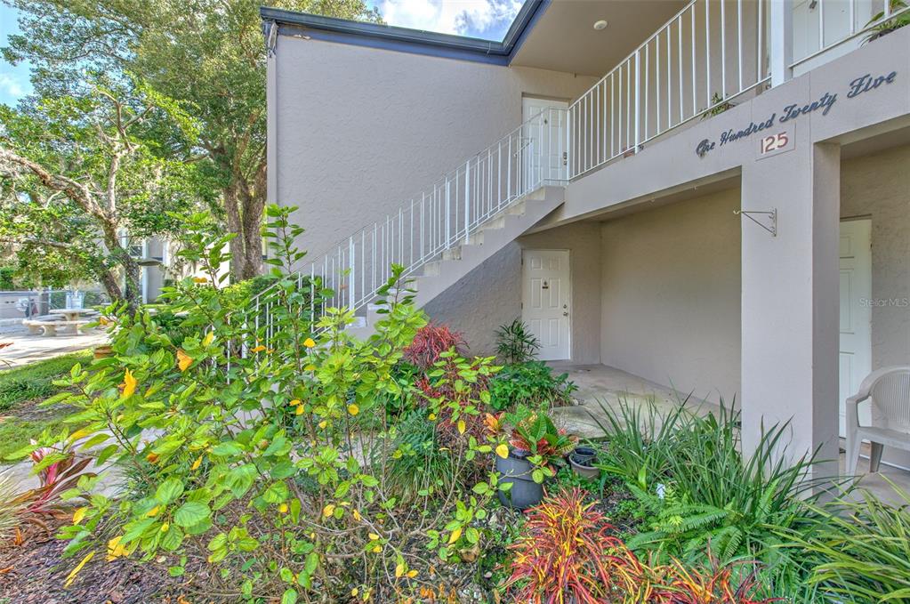 a house with flower garden in front of it