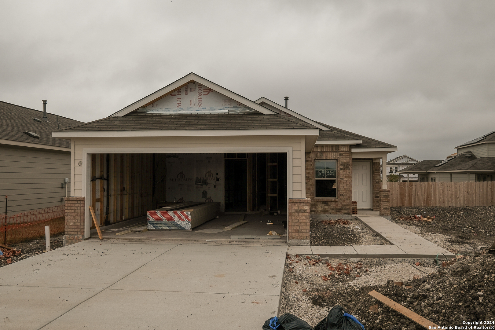 a front view of a house with sitting area