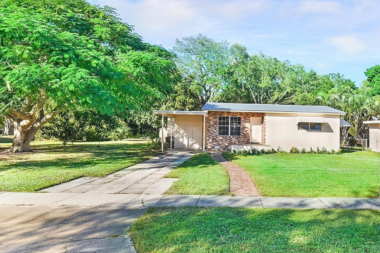 a view of a house with a yard and a garden