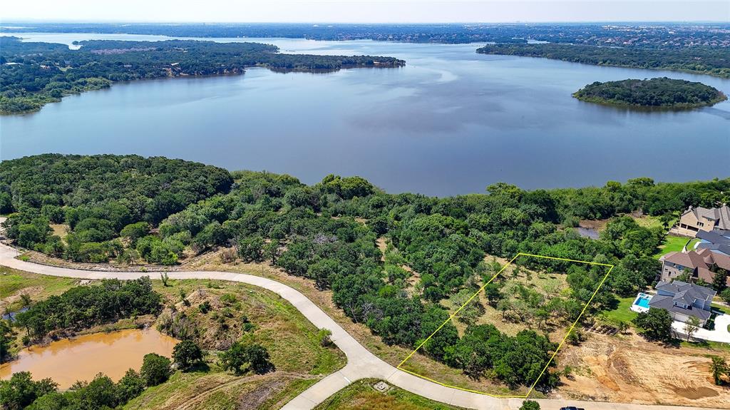 an aerial view of a houses with a lake view