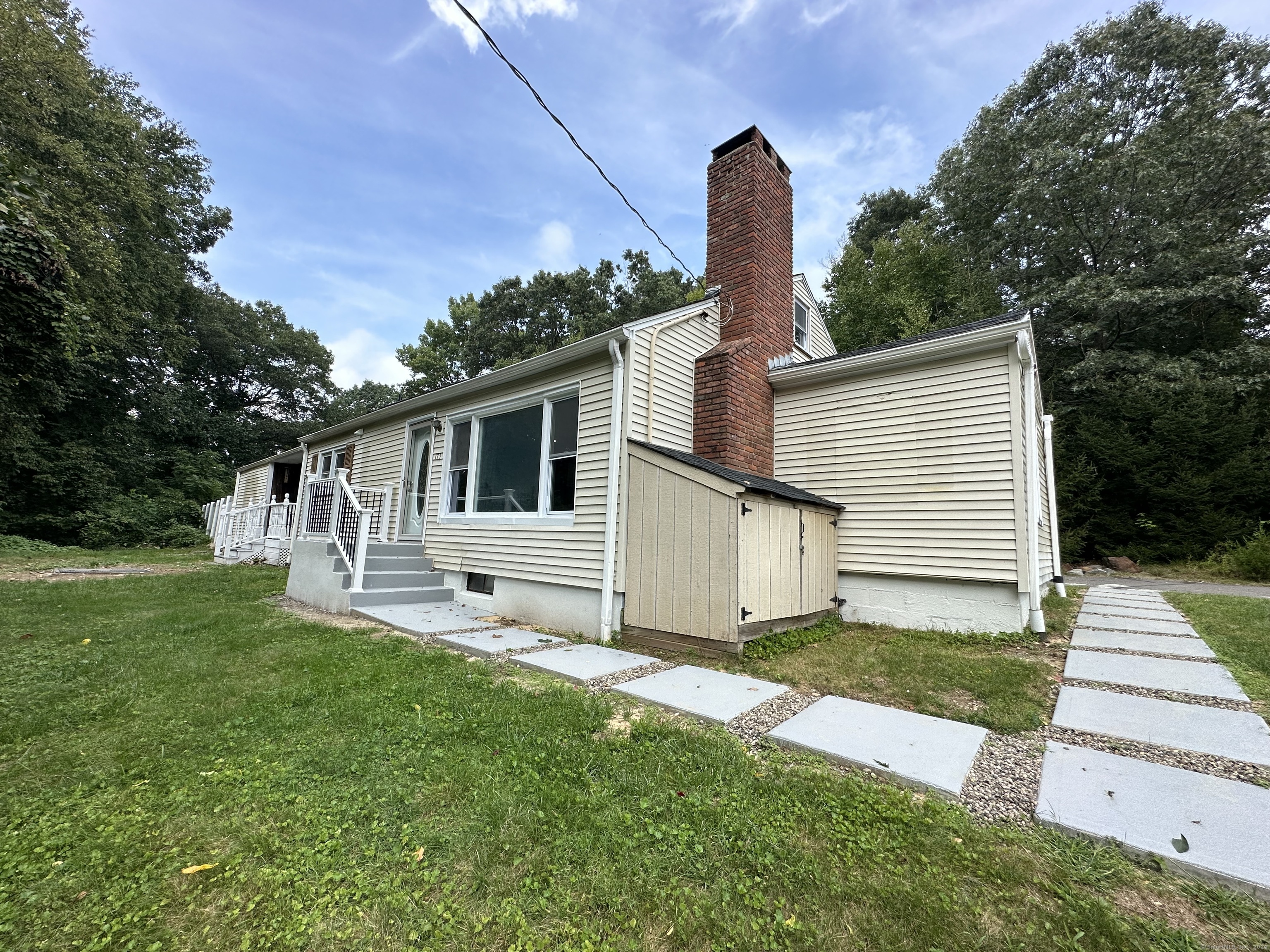 a front view of house with yard and green space