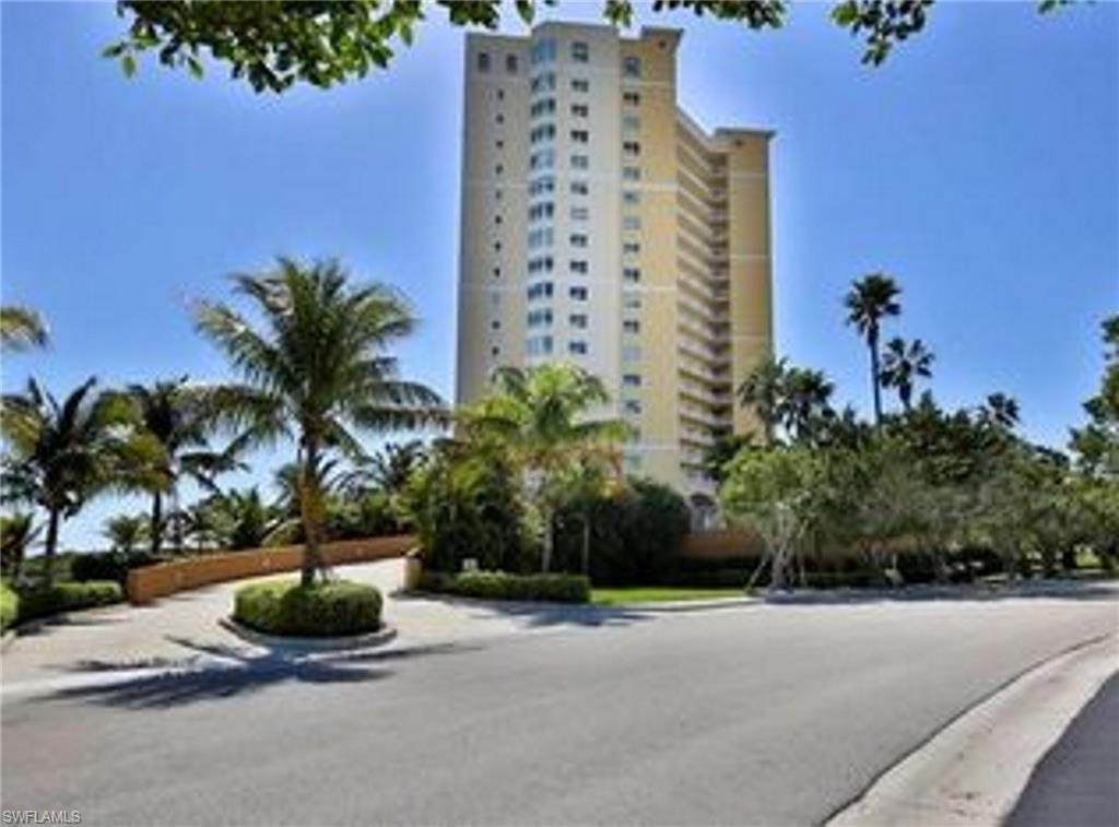 a palm tree sitting in front of a building