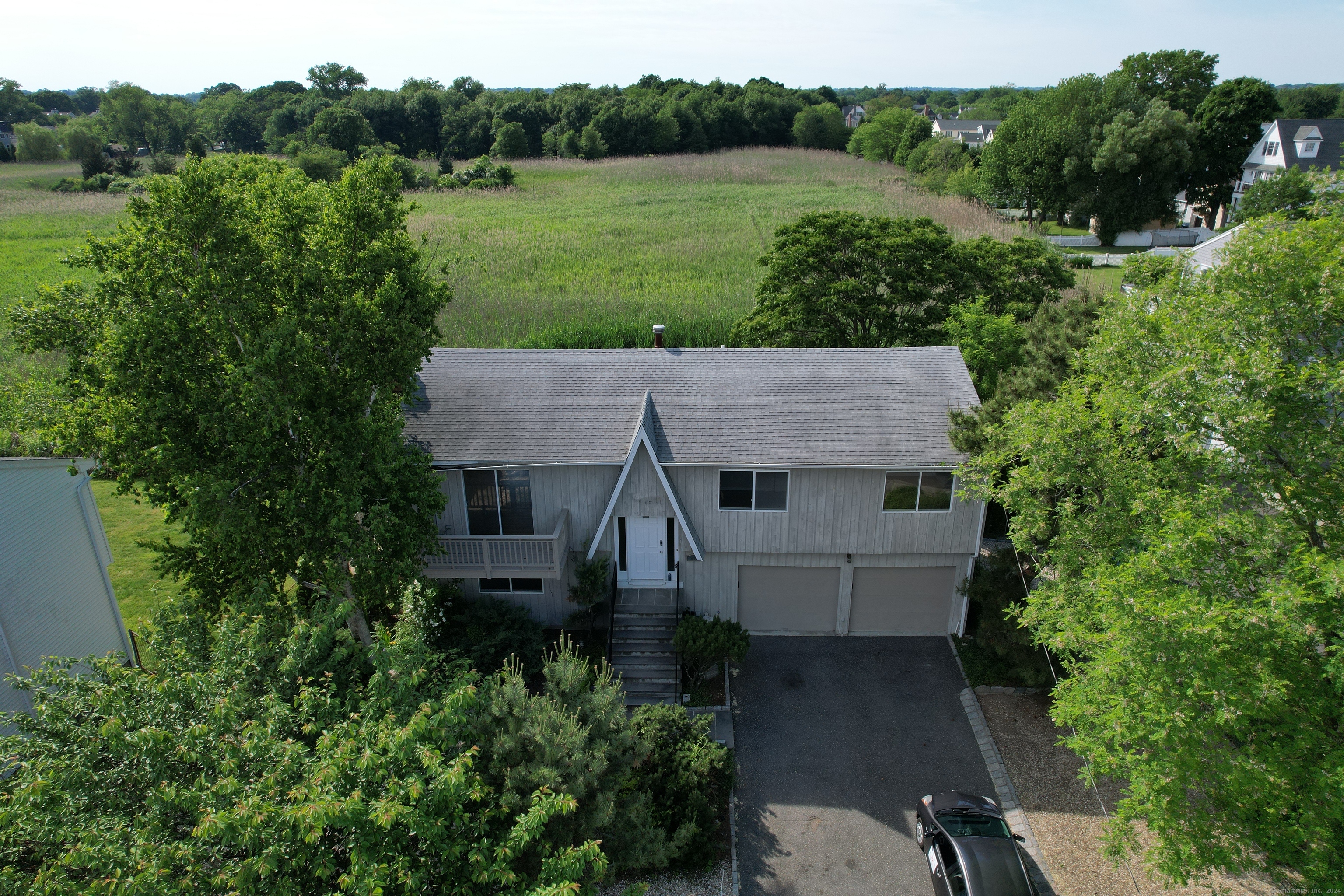 an aerial view of a house with yard and outdoor seating