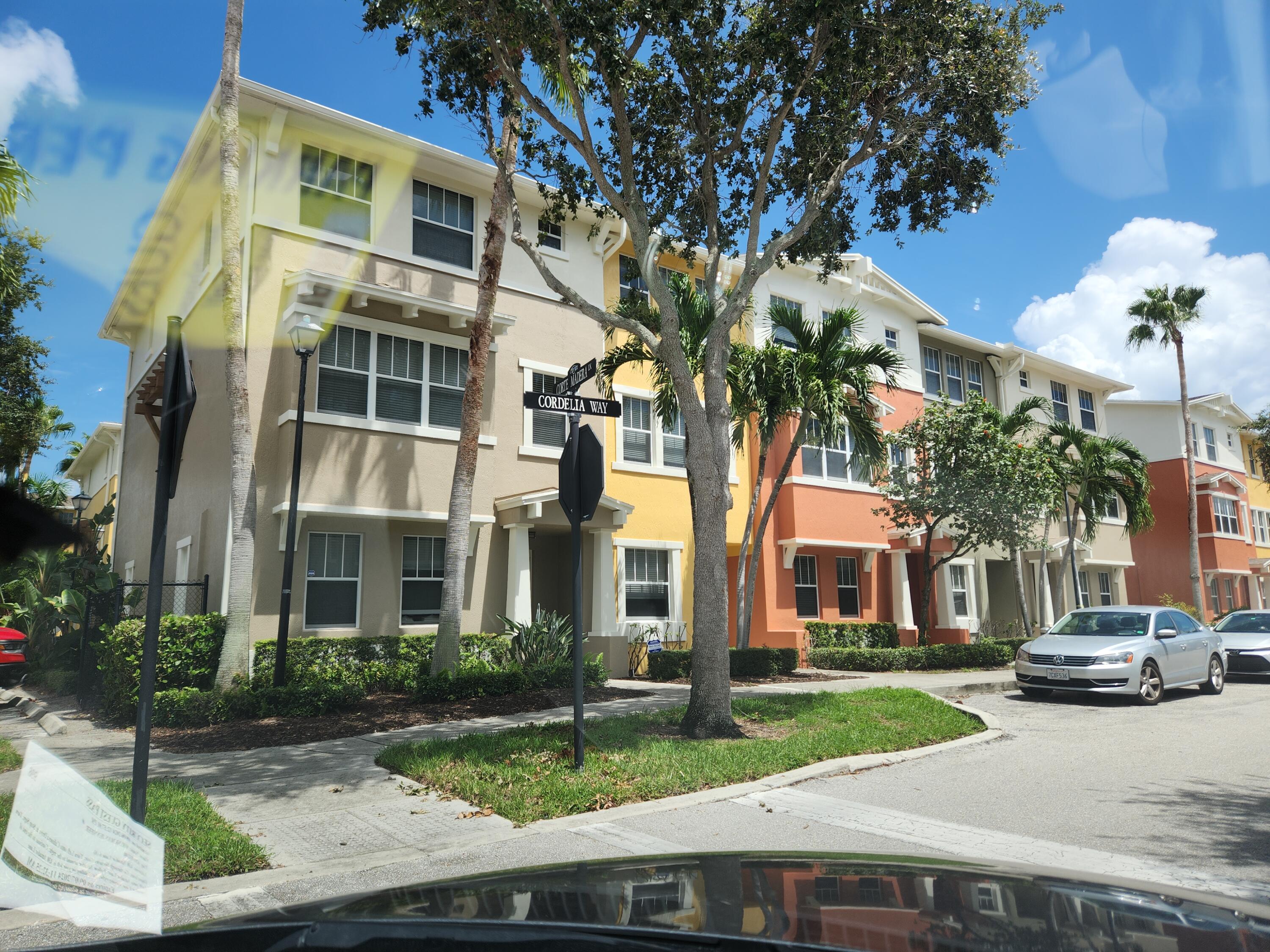 a front view of a residential apartment building with a yard