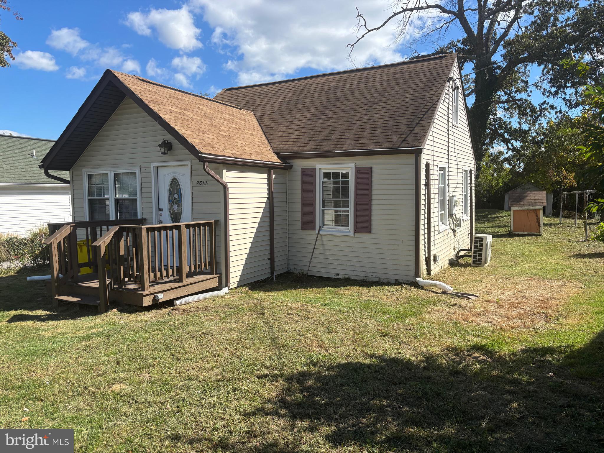 a view of a house with backyard porch and wooden fence