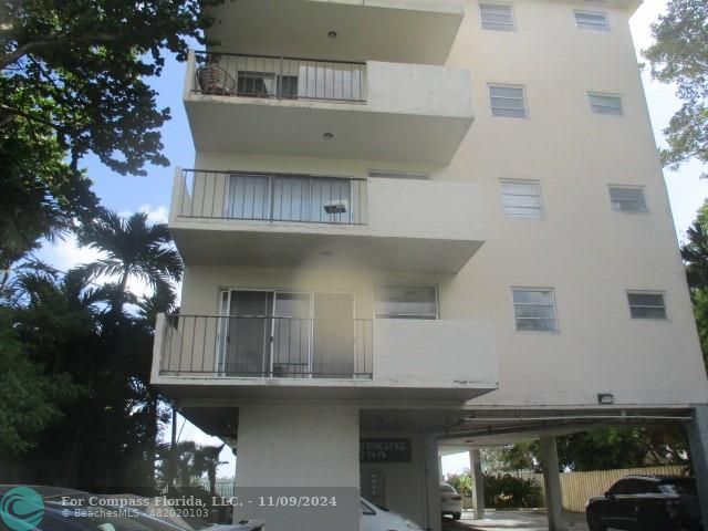 a front view of a building with parking space