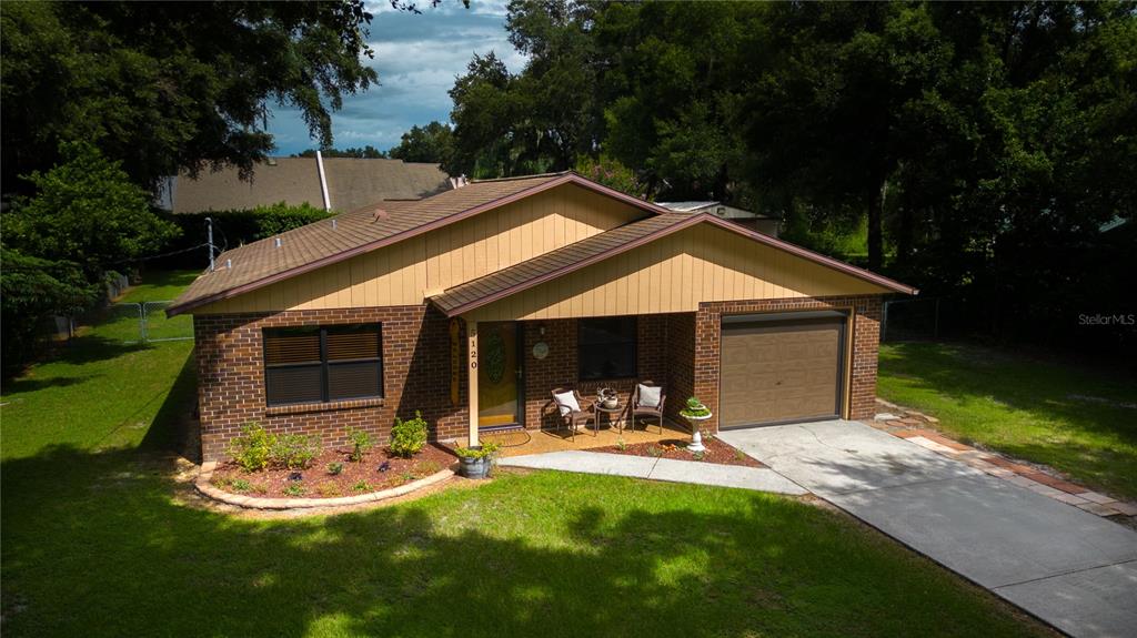 a front view of house with yard and green space