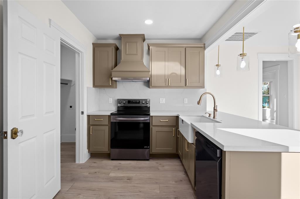 a kitchen with stainless steel appliances a sink stove and refrigerator