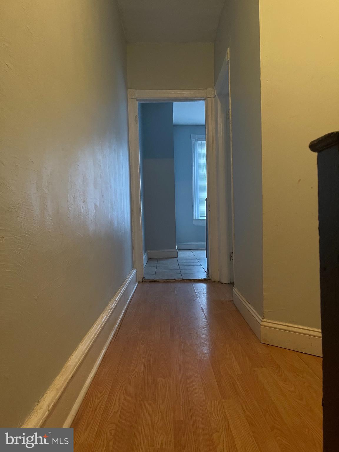 an empty room with wooden floor and closet