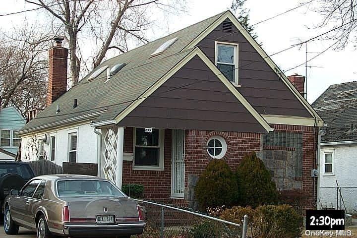 a front view of a house with parking space