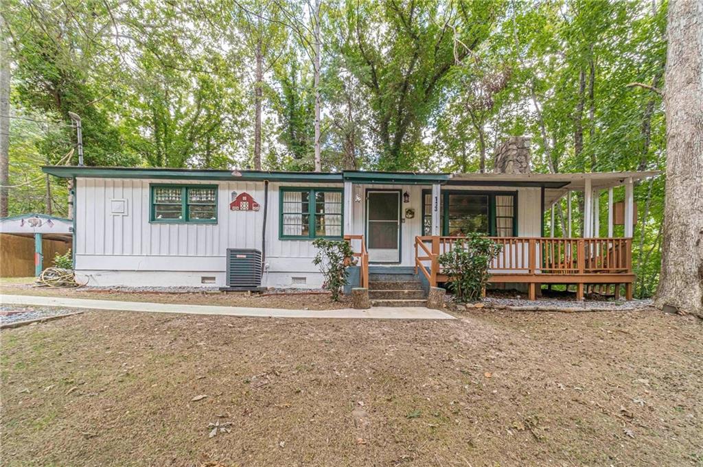 a backyard of a house with table and chairs