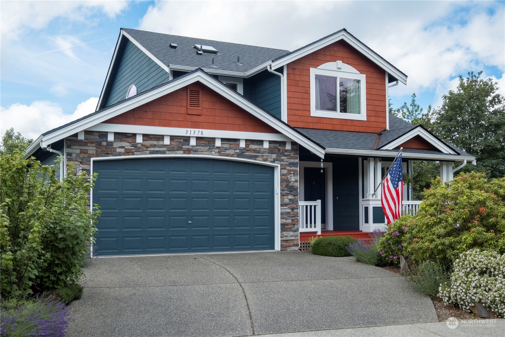 a front view of a house with yard and garage