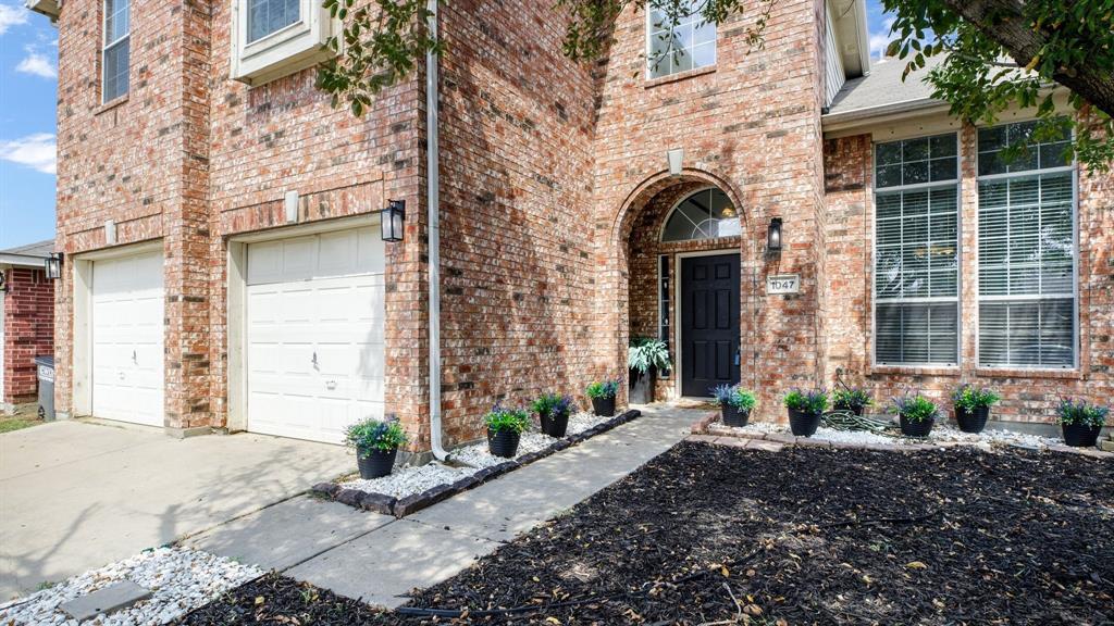 a front view of a brick house with a yard