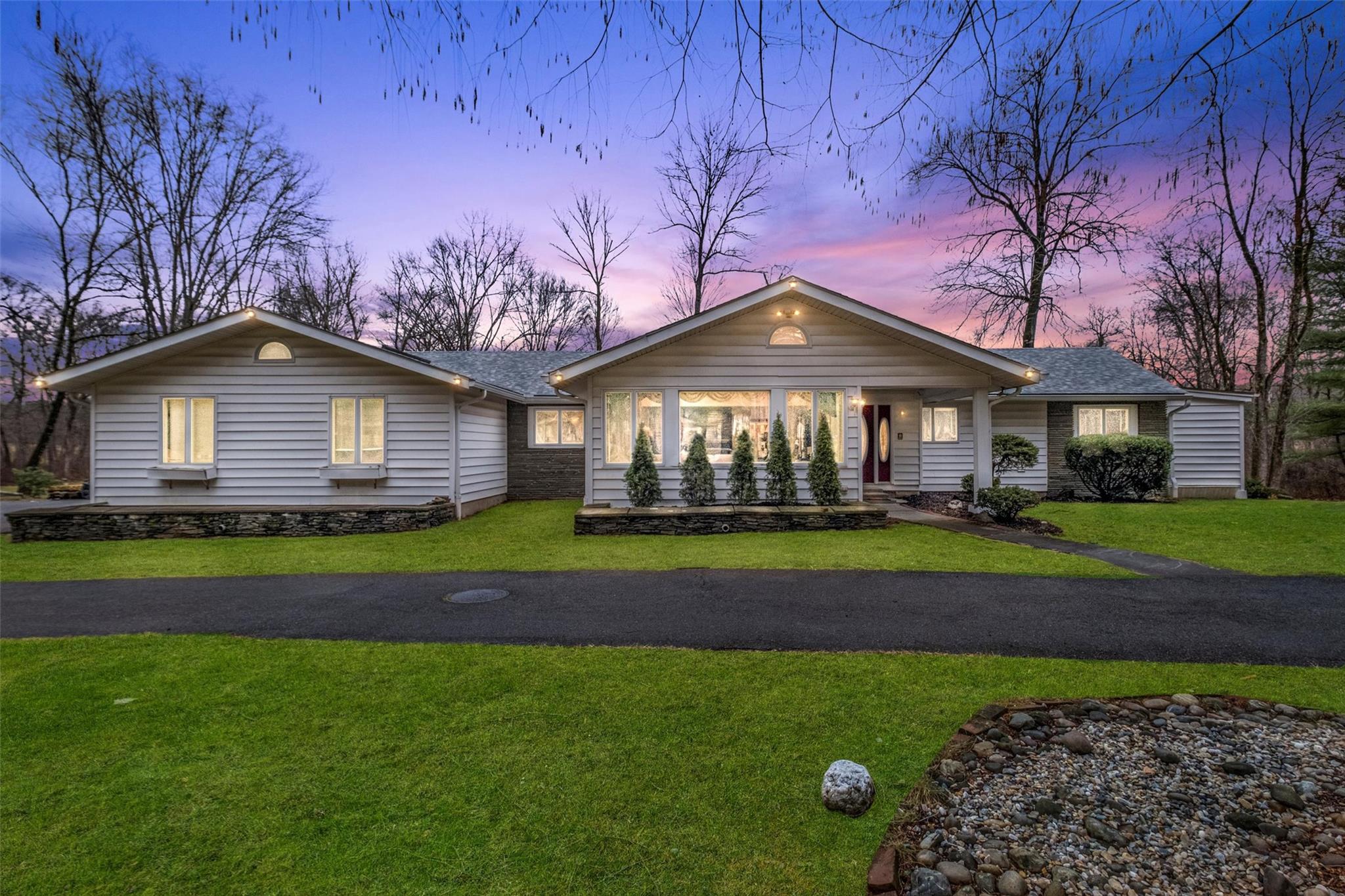 a front view of a house with garden