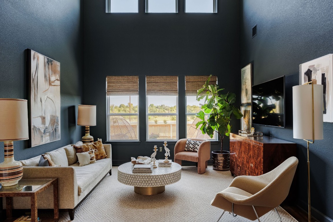 Living room with a view! Show stopping living room with cathedral ceilings, tons of light from the multiple windows,  custom paint and window treatments PLUS views to un-developable land out back... so private!