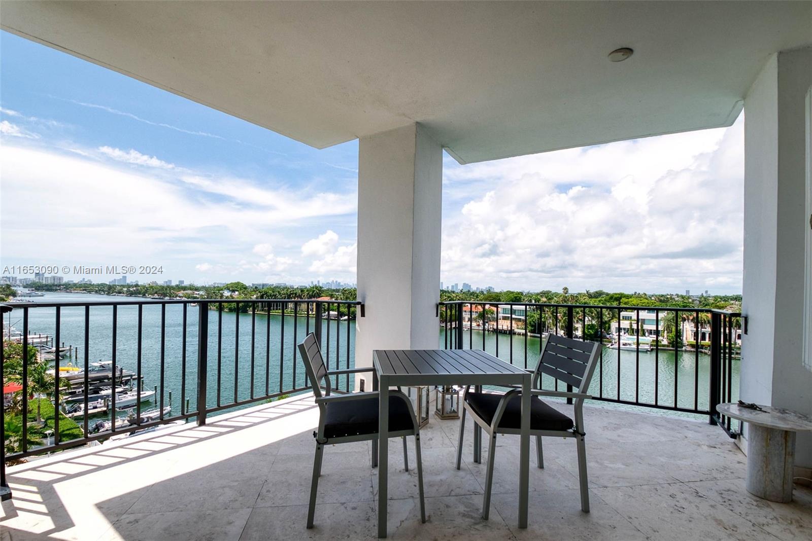 a view of a balcony with chairs and wooden floor