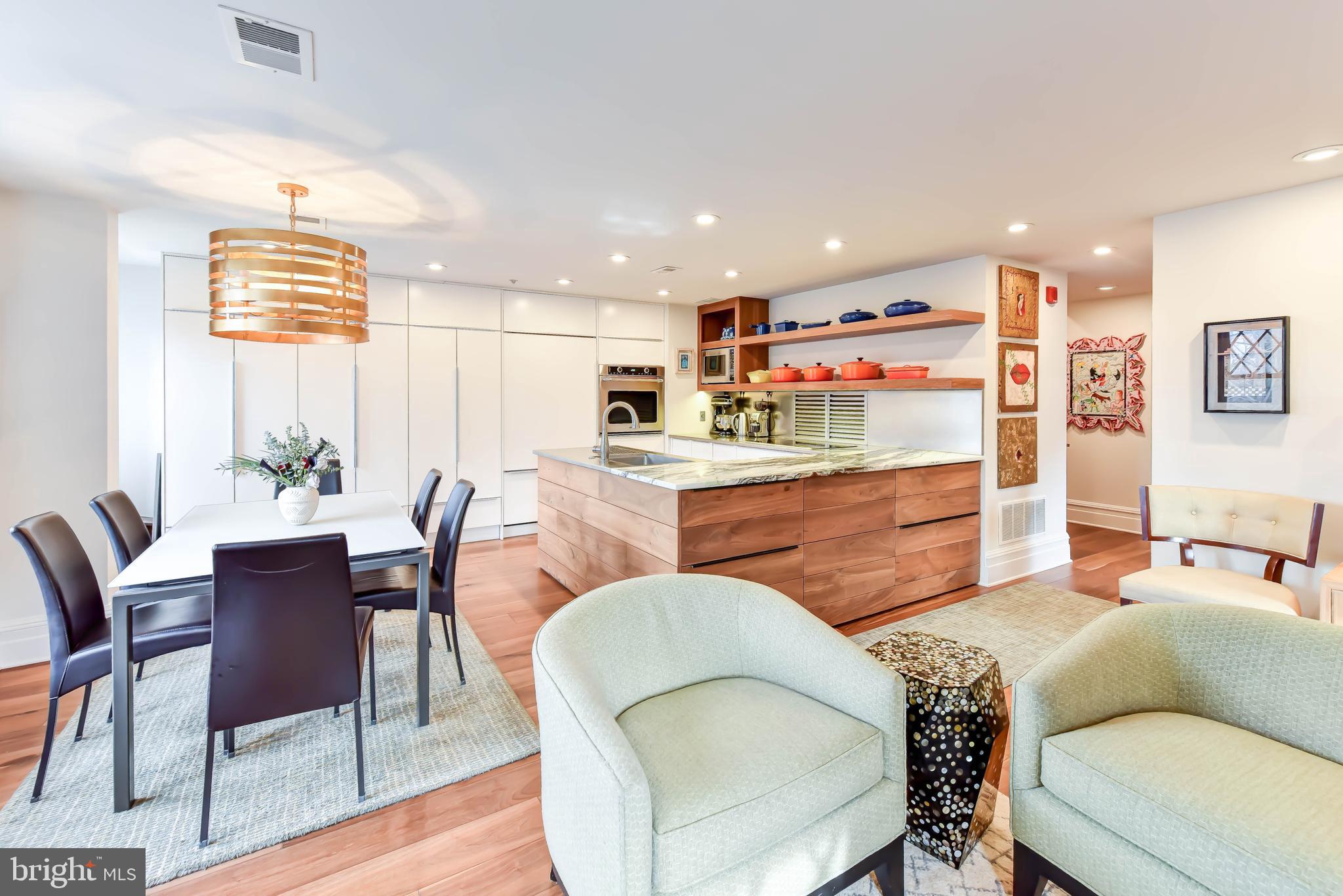 a living room with furniture kitchen and a table