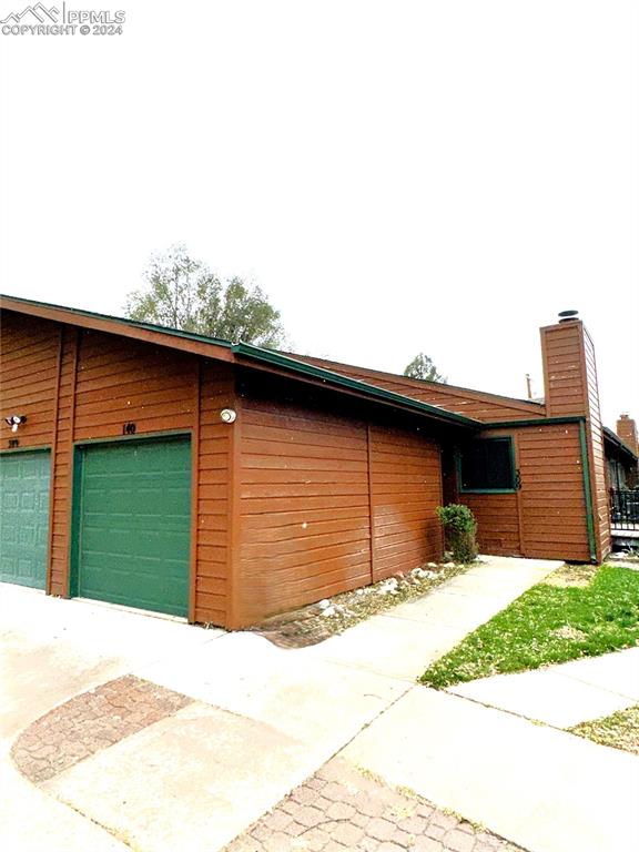 a backyard of a house with yard and garage