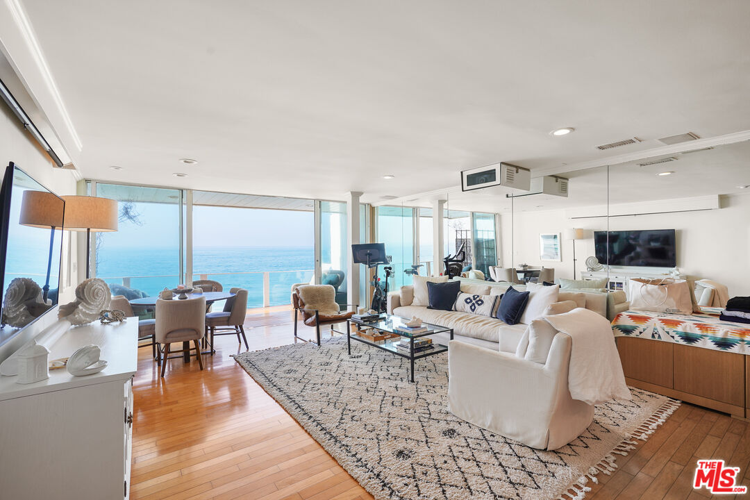 a living room with fireplace furniture and a flat screen tv