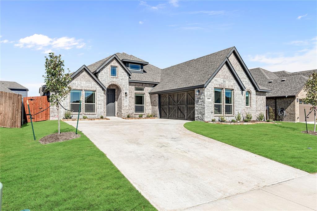 a front view of a house with a yard and garage