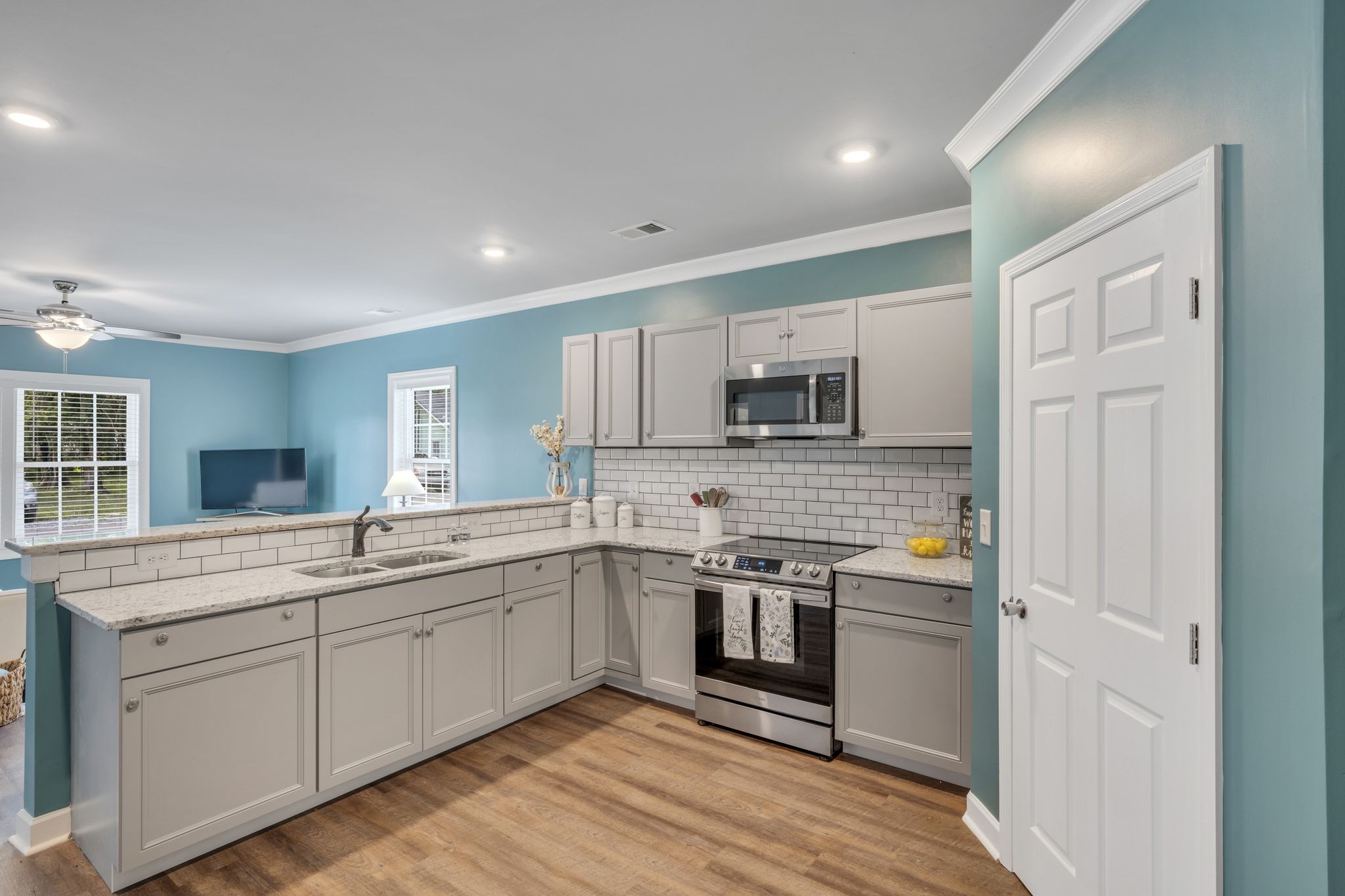 a kitchen with stainless steel appliances granite countertop a sink and stove top oven