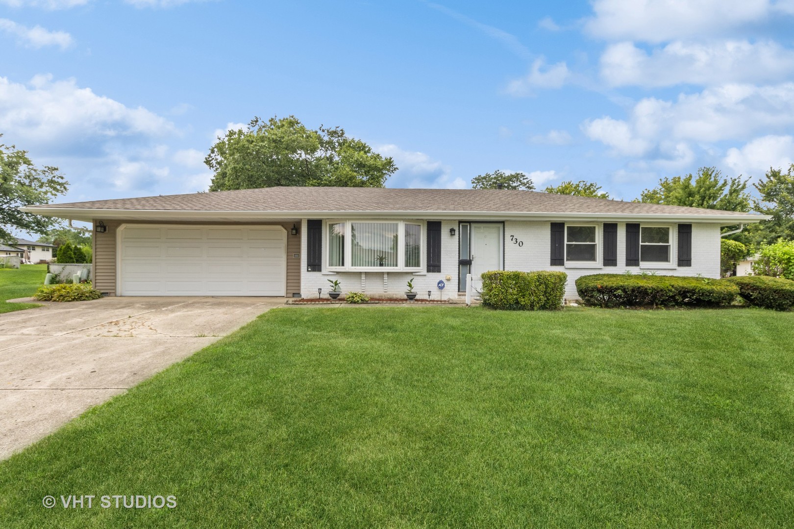 a front view of house with yard and green space