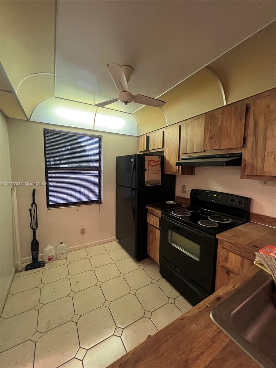 a kitchen with stainless steel appliances granite countertop a stove and a refrigerator