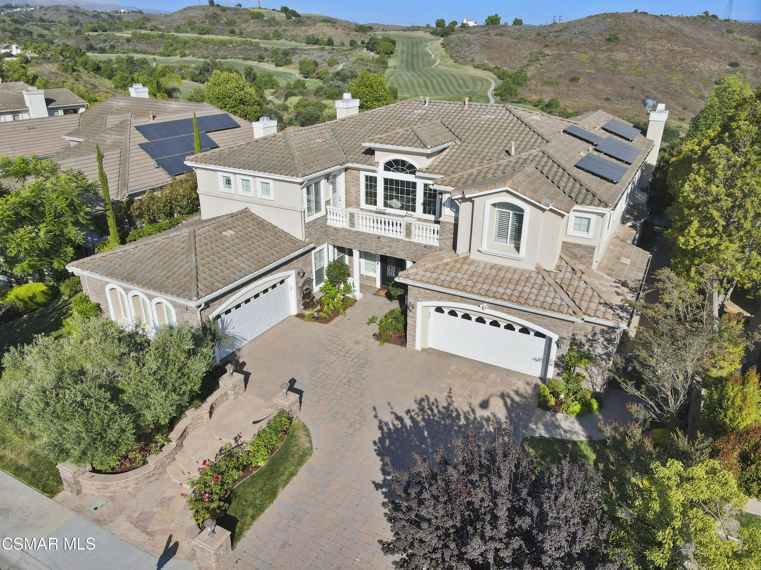 an aerial view of residential houses with outdoor space and trees